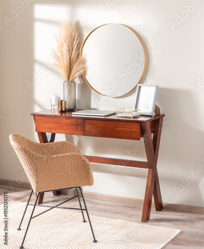 an interior view of a contemporary home office featuring a wooden desk and a wall-mounted mirror