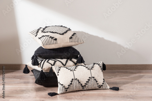 cushions of different shapes and colors are lying on the floor, stacked on top of each other