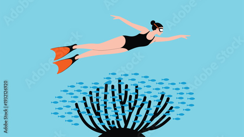 Female swimmer in goggles and fins glides above a dark coral reef with small blue fish