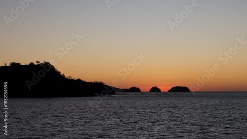 Aerial slow movement over tropical ocean at sunset afterglow
