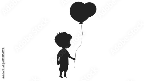 Silhouette of young boy holding heart shaped balloon