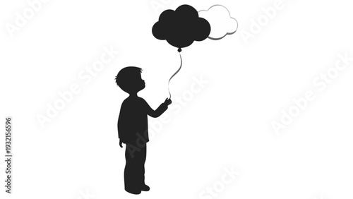 Little boy holding black and white balloons in silhouette