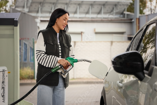 Young happy woman filling u...