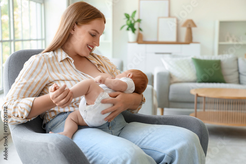 Beautiful young mother brea...