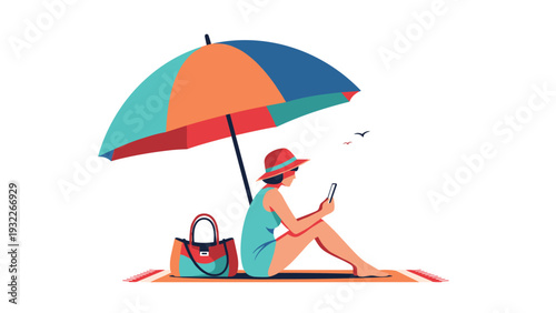 Relaxed woman sitting under a large colorful beach umbrella while using her phone on a sunny day at the seaside.