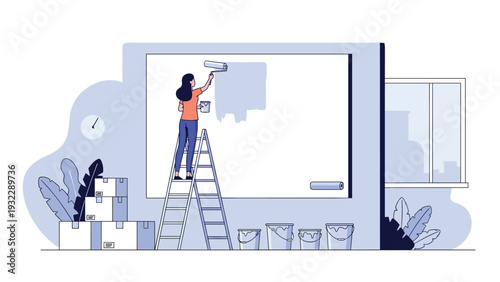Woman standing on tall ladder painting large wall with roller in new house surrounded by boxes and paint buckets.