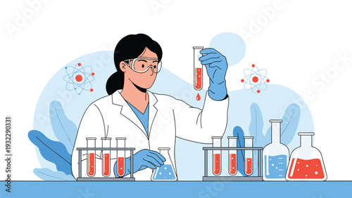 Professional female scientist in a lab coat examines red liquid in a test tube while working in a high tech laboratory.