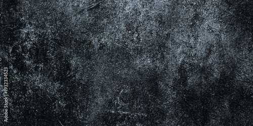 A monochromatic wall textured background displays a rough dark surface with subtle variations in tone and depth