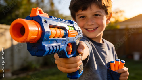 A boy playing with nerf gun outdoor, Pointing a toy blaster and smiling, Funny kids game, childhood activity, toy gun
