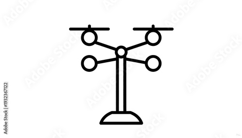 A black-and-white vector illustration. The central pole supports four arms, each with a rotating spherical element. Base
