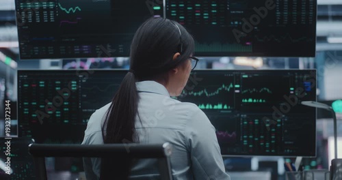 Professional Asian Woman Dressed in Business Attire Works Cutting Edge Station in Massive Exchange Center. Concept of High Productivity Environments and Evolution of Innovative Digital Office.