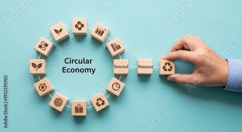 Hand connects recycle block completing circular economy concept model