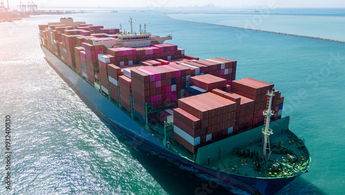 Wallpaper Mural Massive container ship fully loaded with colorful freight sailing across the deep blue ocean. Global maritime logistics, international trade, and commercial shipping industry business concept. Torontodigital.ca