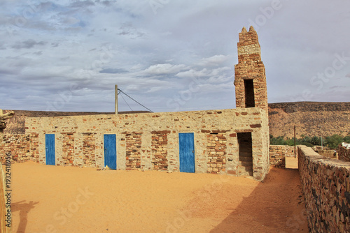 The ancient mosque of the local village close old city Ouadane in Sahara desert, Mauritania