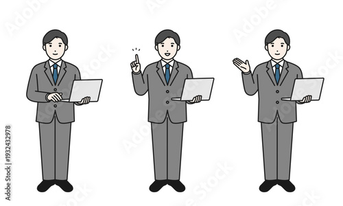 ノートパソコンを持って立っているビジネスマン