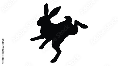A black silhouette of a rabbit in mid leap showcasing dynamic movement