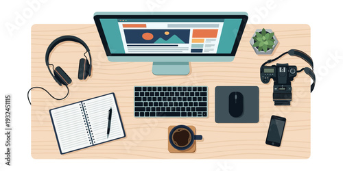 A creative workspace with a computer, notebook, and office supplies on a wooden desk viewed from above