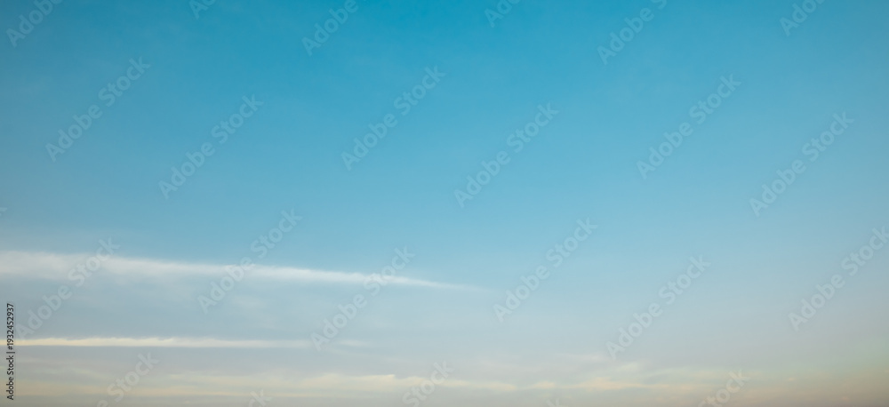 Obraz premium the sky is clear blue with fluffy white clouds, the sky is very bright, and the sun shines.