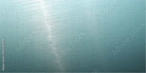 A shiny brushed metal plate features a textured stainless steel surface with a grey metallic pattern and light chrome reflections for an industrial silver aluminum backdrop design