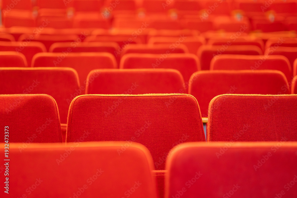 Naklejka premium empty auditorium or theater with red velvet seats, no audience, background.