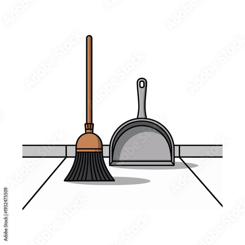 Broom and dustpan cleaning tools on a tiled floor isolated on white background