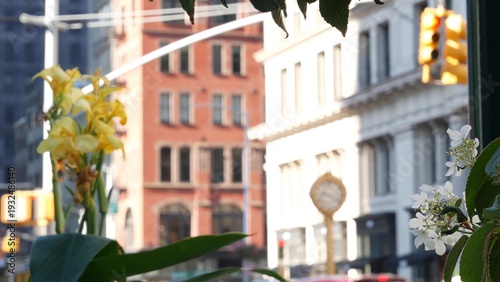 New York City Manhattan Midtown, United States of America. Street Clock on Broadway in Flatiron district near Madison Square Park. 5 fifth avenue Nomad area. Iconic golden clock. Autumn fall flowers.