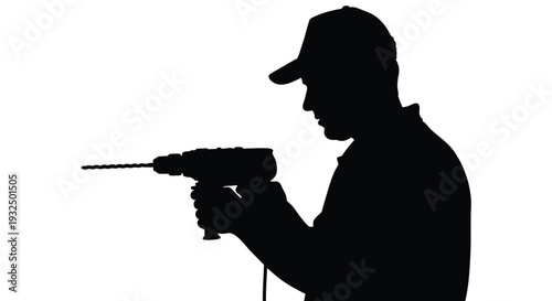 A worker using a power drill shown in stark black silhouette