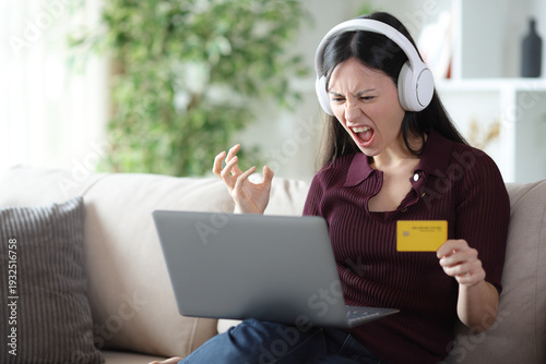 Angry asian woman having problems paying media online