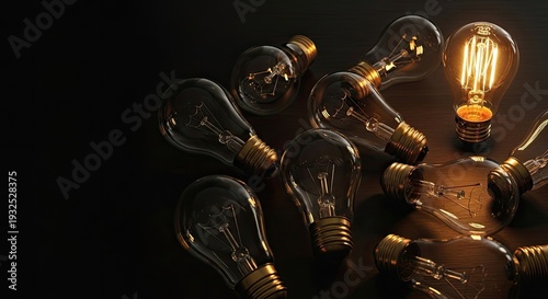 edison light bulbs scattered on dark wood, one glowing warm amber, idea inspiration concept