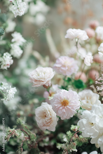 Blush pink and white flowers blooming in a soft and dreamy green garden, creating a delicate floral composition for background