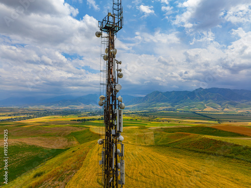 Fotografi Tall telecommunications tower stands prominently in serene rural landscape
