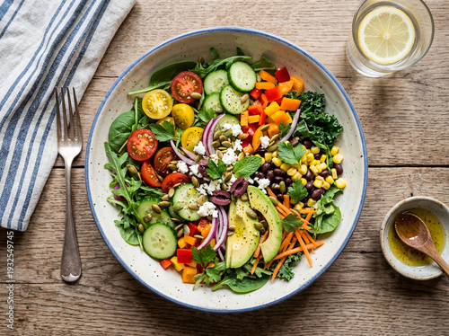 Healthy Mediterranean Buddha Bowl with Avocado, Fresh Vegetables, and Feta Cheese on Rustic Wooden Background