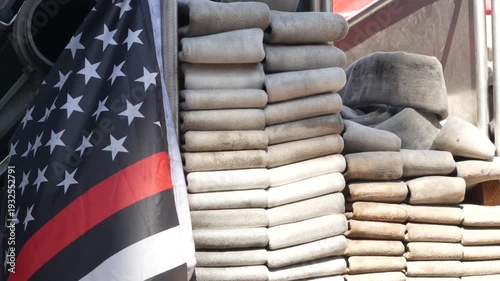 Red thin line black american flag on firefighter truck. Hose of firetruck and fire fighters symbol in New York, United States. 911 remembrance, fire department engine vehicle. September 11 Patriot Day