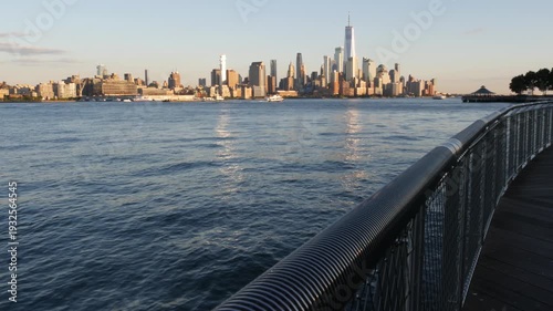 New York City Manhattan Downtown Financial District skyline, World Trade Center tower from New Jersey, Hoboken pier, United States of America. River waterfront urban cityscape with skyscraper building