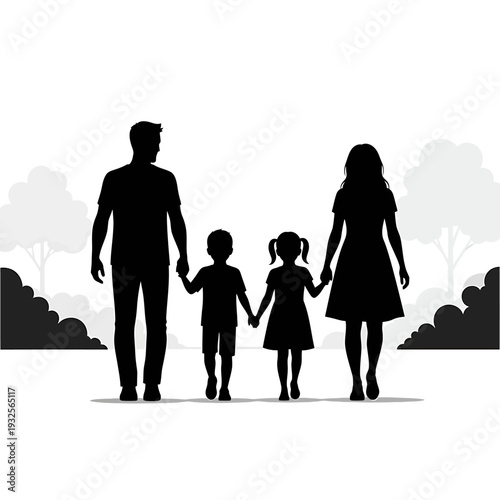 Silhouette of a family with two children walking hand in hand in a park with trees and bushes in the background.