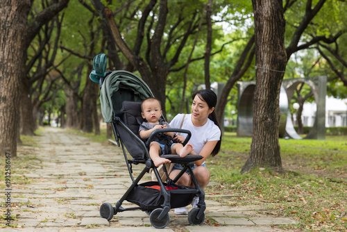 Fotografía Mother and baby in park with stroller outdoors