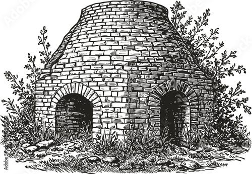 Old brick kiln with two arches surrounded by grass and bushes historic stone furnace outdoor structure