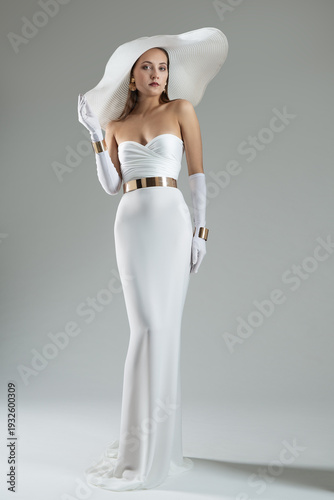 Wallpaper Mural Lady in White Dress and Wide Brim Hat. Wedding Fashion. Elegant Woman wearing evening Long Gown with Gloves over Gray background Torontodigital.ca