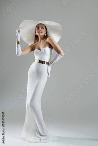 Wallpaper Mural Elegant Happy Woman White Dress and Wide Brim Hat. Wedding Fashion. Lady wearing evening Long Gown with Gloves over Gray background Torontodigital.ca