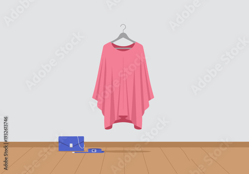 A pink poncho hangs on a hanger against a white wall. A blue handbag rests below. Clean, flat design illustration for fashion mockups.