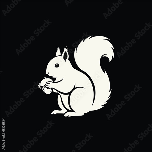 White squirrel holding a nut in its paws.