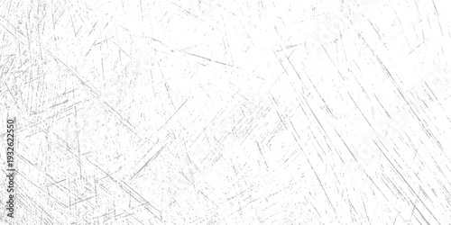 White surface with numerous fine grey scratches and speckles creating a textured background