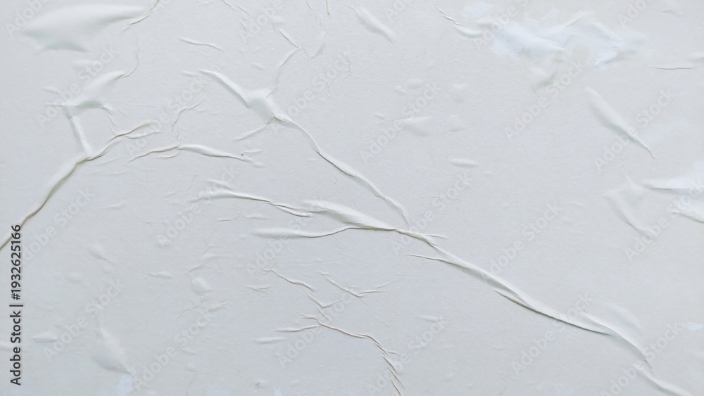 Obraz premium Blank abstract background of white crumpled paper. Creased poster texture with wavy surface. Wrinkled white paper background detail.