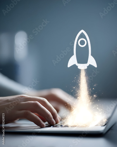 Person typing on laptop with rocket icon launching from keyboard in modern office setting viewed from behind
