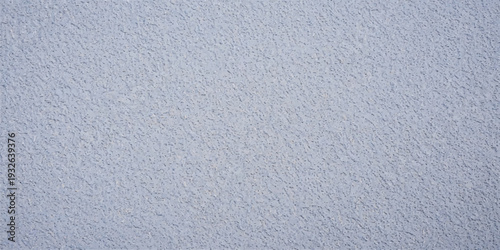 Light blue textured plaster wall surface, fine grain and subtle pattern creating a uniform background for interior design and graphic applications