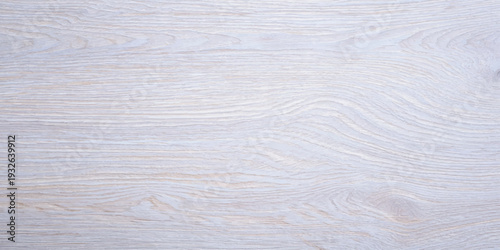 Clean, light wood grain background with delicate, flowing lines and a pale, almost white wash.