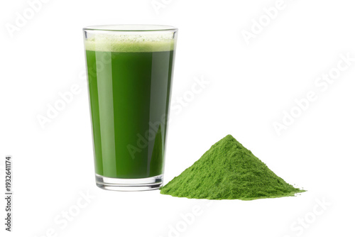A glass of green juice and a pile of wheatgrass powder