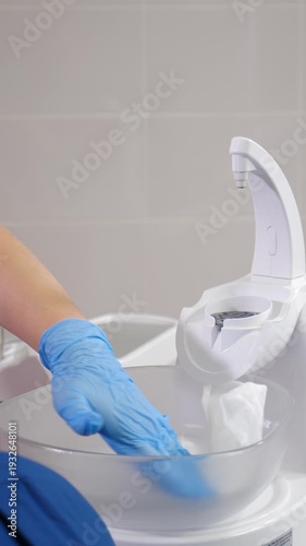 Modern dental clinic. medical female assistant cleaning and disinfecting dental facility with napkin and antibacterial sanitizer. Sterilization and disinfecting medical dental unit. 4 k video