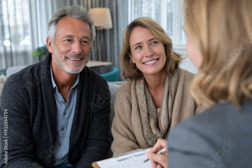 adult couple talking with therapist in bright counseling office, supportive professional setting, neutral tones, natural window lighting, balanced composition
