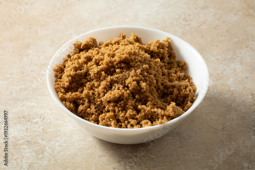 A view of a bowl of dark brown sugar.